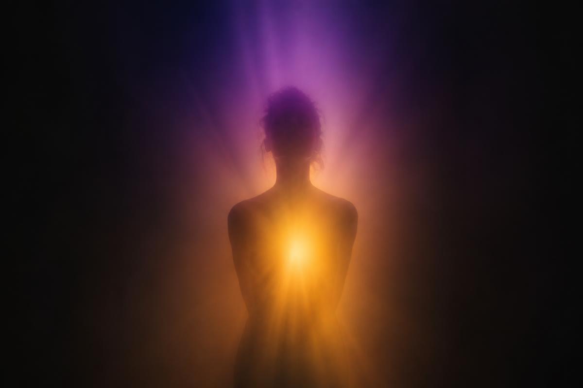 Abstract silhouette emerging from violet and amber light